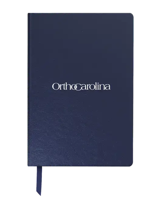 Achieve Navy Hardcover Journal, 5.5 x 8.37 w/OrthoCarolina Logo